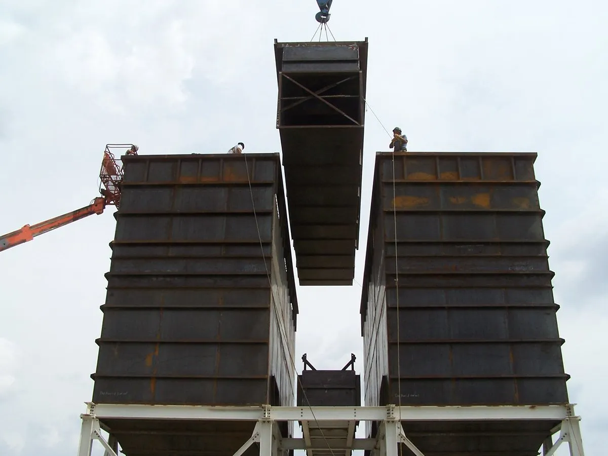 Center section of M-Pulse baghouse dust collector being  installed with a crane.